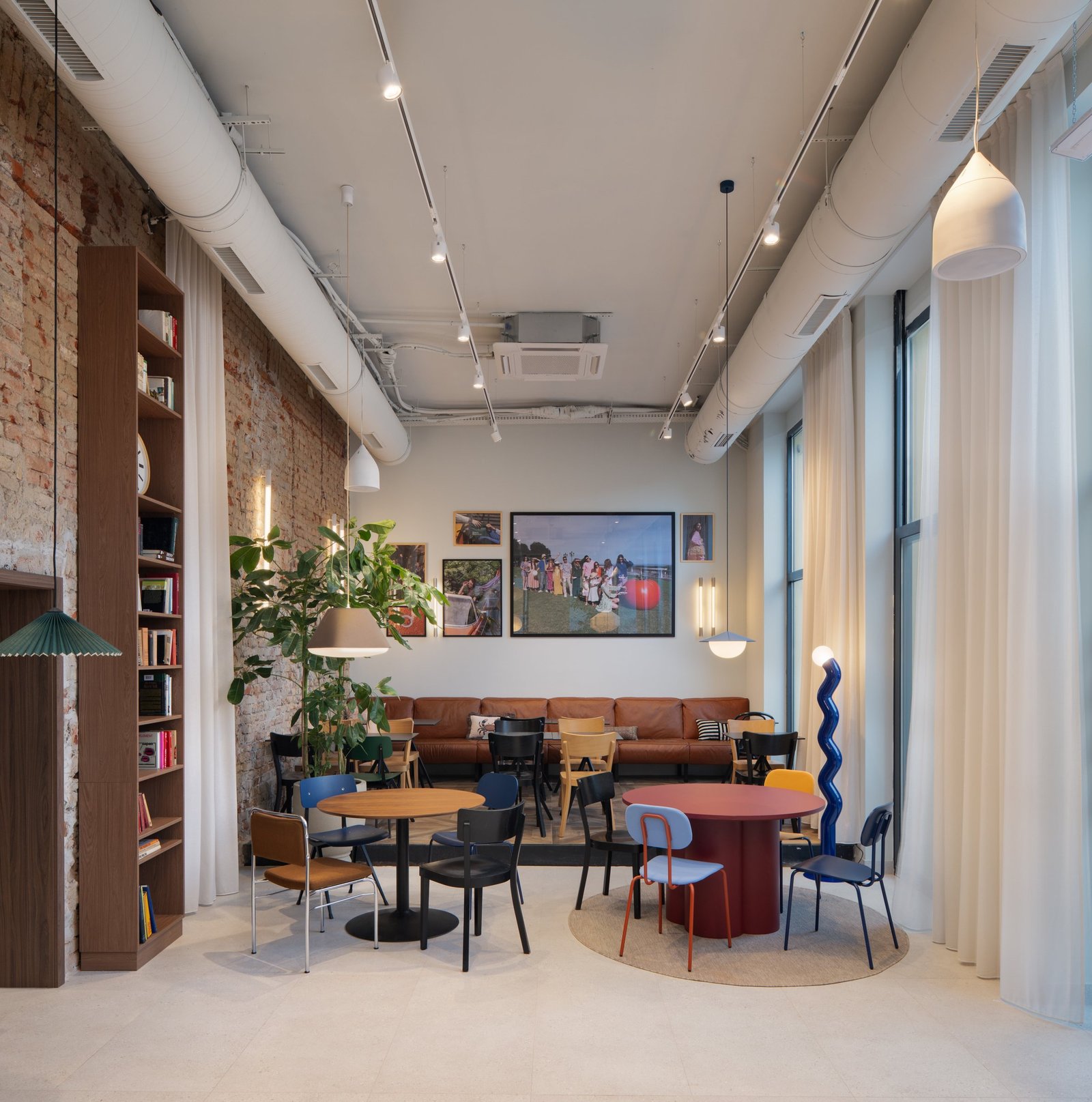 Bites and Beyond: long dining room with brick wall and bookshelves